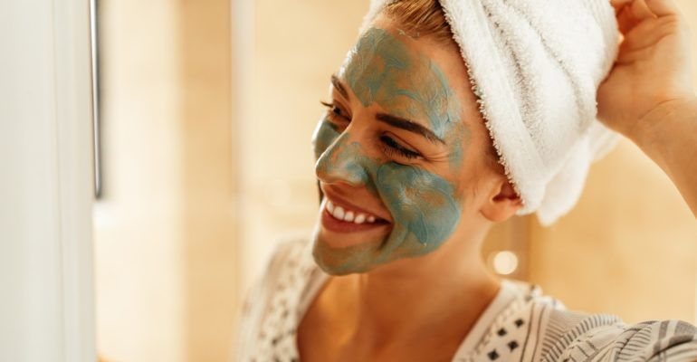 A close up shot of an attractive young woman standing in the bathroom